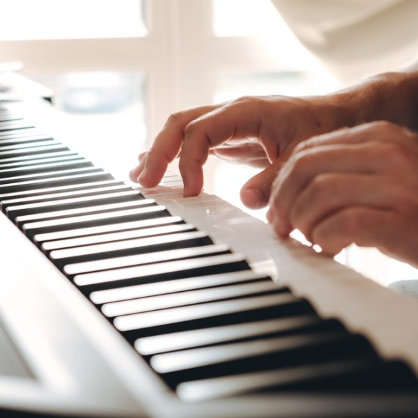 An,Unrecognizable,Man,Learns,To,Play,The,Piano.,Music,Lesson.